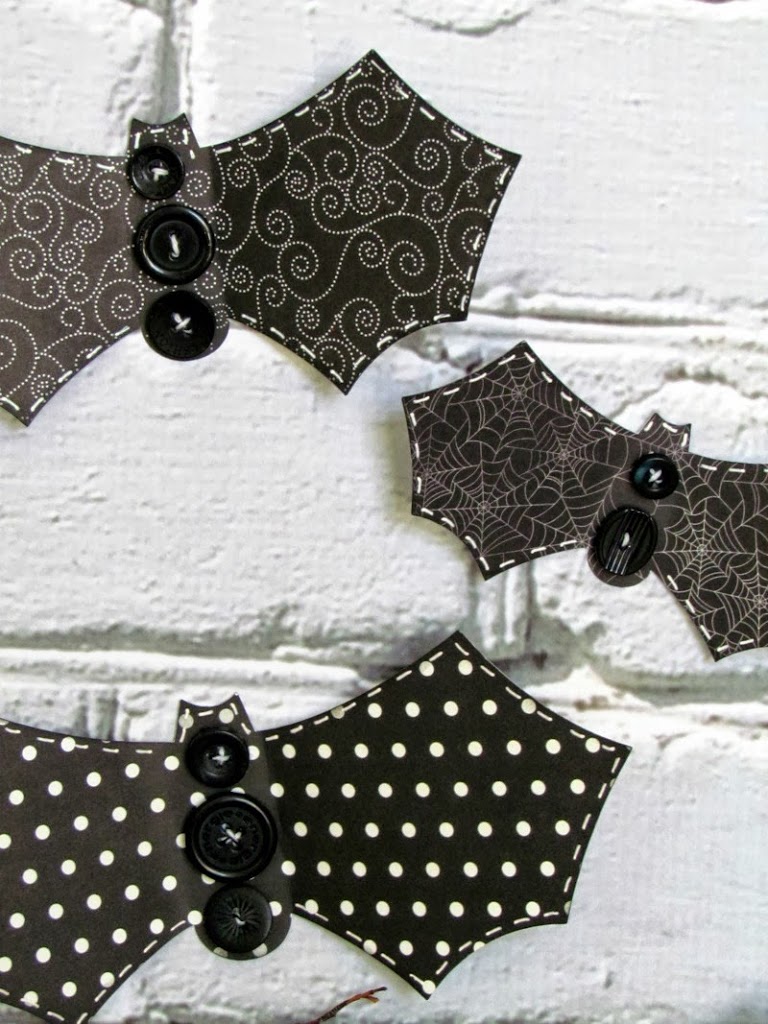 Make these simple Button Bat craft using Halloween scrapbook paper and black buttons 