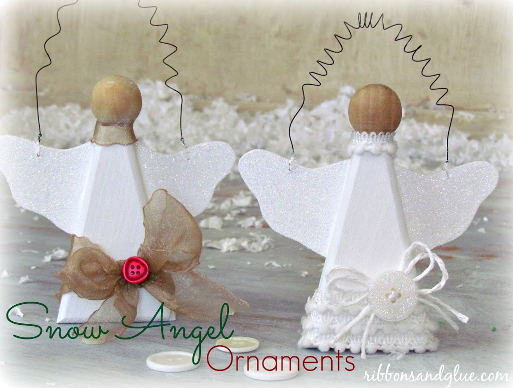 Snow Angel Ornaments made out of wood angels painted white and made sparkly with glitter, buttons and ribbon
