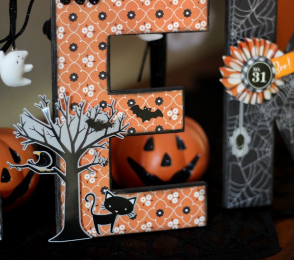 Create Decoupaged Halloween Letters by using mod podge to adhere Halloween themed paper on to paper mache letters and embellish. 