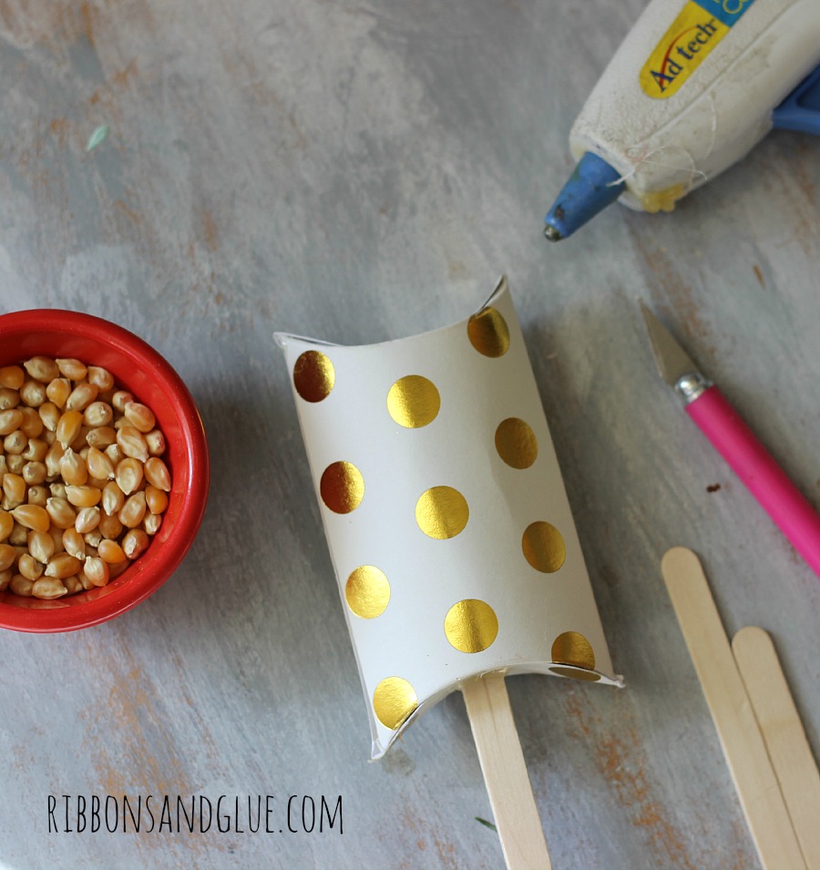 DIY New Year's Eve Shaker Boxes made from a pillow box on a stick with popcorn kernels inside!
