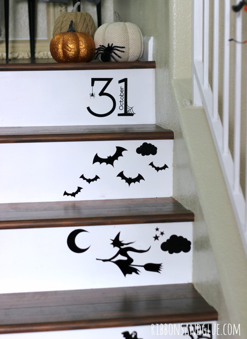 Create a Halloween Staircase by using a die cutting machine to cut out black vinyl Halloween shapes. Easy Halloween Decor idea. 