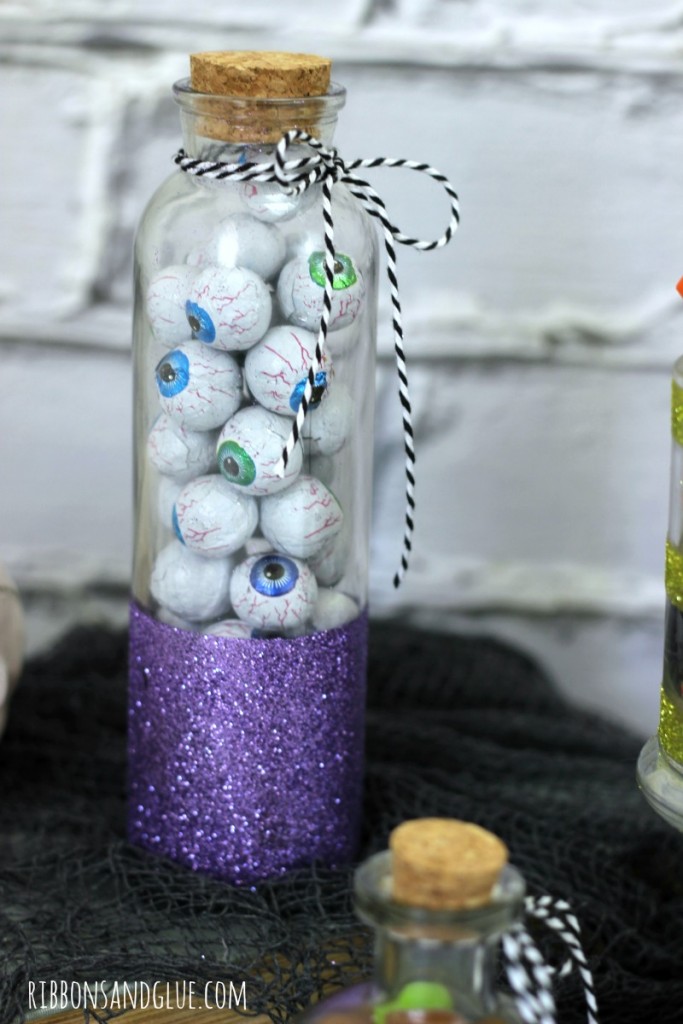 Create DIY Halloween Candy Glitter Jars out of empty glass jars, glitter and adhesive. Spooky cute to fill up with candy for Halloween. 