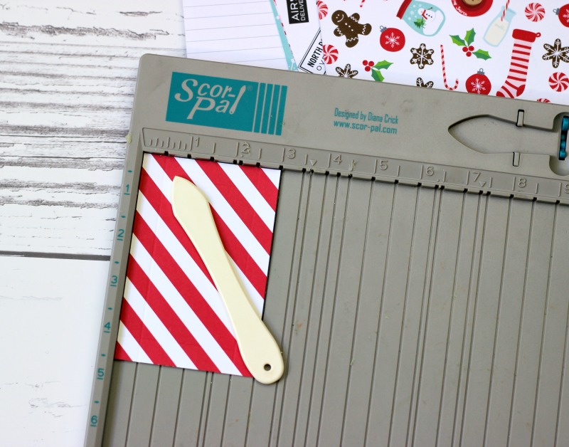 How to make a Holiday Gift Box Bag out of scrapbooking paper and a score board. 